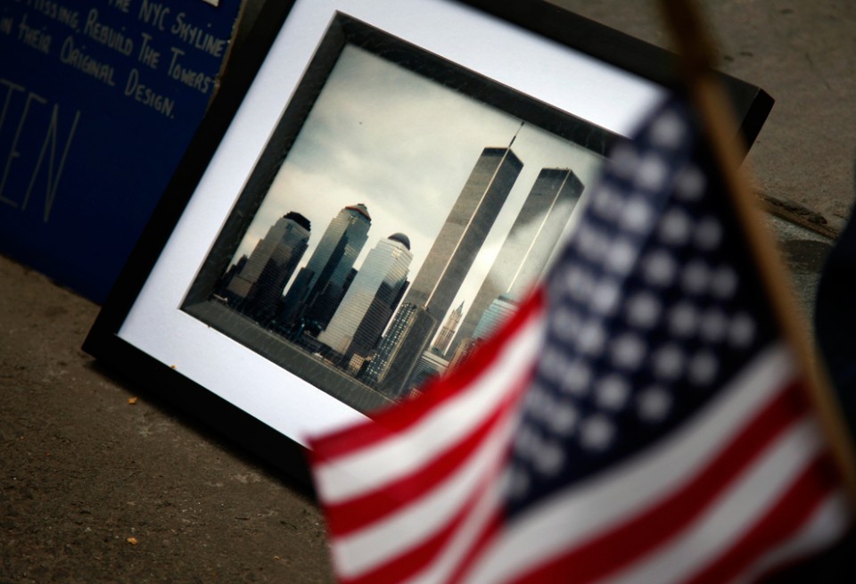 A-framed-photo-of-the-Twin-Towers-sits-against-a-curb-in-honor-of-a-911-victim-near-Ground-Zero-during-the-10th-anniversary-ceremony-September-11-2011-in-New-York.-Tom-FoxThe-Dallas-Mornin